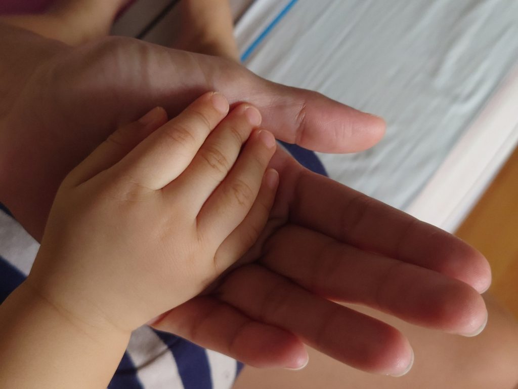 Mother holding her child's hand